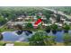 Scenic aerial view of townhomes near a pond, beautifully capturing the community's layout and peaceful environment at 135 Moonstone Ct, Port Orange, FL 32129