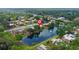Stunning aerial view of a community of townhomes alongside a tranquil pond, showcasing its attractive setting at 135 Moonstone Ct, Port Orange, FL 32129