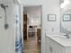 View from bathroom to the kitchen and dining area, showcasing the home's open layout at 135 Moonstone Ct, Port Orange, FL 32129