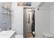 Cozy bathroom featuring a shower and stacked washer-dryer at 135 Moonstone Ct, Port Orange, FL 32129