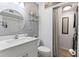 Bright bathroom with white vanity, round mirror, and decorative shelving at 135 Moonstone Ct, Port Orange, FL 32129