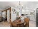Cozy dining area with a round table, wood floors, white cabinetry, stainless steel appliances, and easy access to the kitchen at 135 Moonstone Ct, Port Orange, FL 32129