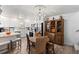 Inviting dining area with modern lighting, white cabinetry, stainless steel appliances, and a view of the updated kitchen at 135 Moonstone Ct, Port Orange, FL 32129
