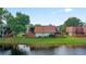 Water view showing a fenced yard with a patio overlooking the picturesque lake at 135 Moonstone Ct, Port Orange, FL 32129