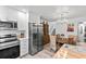 Open concept kitchen and dining area with stainless appliances and stylish chandelier at 135 Moonstone Ct, Port Orange, FL 32129