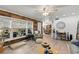 Inviting living room with a cozy armchair, wood floors, a decorative wood wall, and lots of natural light at 135 Moonstone Ct, Port Orange, FL 32129