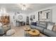 Spacious open-concept living room with hardwood floors, stylish furniture, and seamless flow into the dining area at 135 Moonstone Ct, Port Orange, FL 32129
