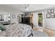 Sunny main bedroom with private balcony, mirrored closet, and ceiling fan at 135 Moonstone Ct, Port Orange, FL 32129