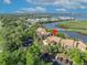 An aerial view with a pin highlights this multi-Gathering home nestled among lush trees, with water views and parking at 1401 S Palmetto Ave # 300, Daytona Beach, FL 32114