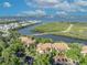 An aerial view shows this property nestled among lush trees with water views and ample parking spaces at 1401 S Palmetto Ave # 300, Daytona Beach, FL 32114