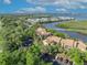 An aerial view shows this property nestled among lush trees with water views and ample parking spaces at 1401 S Palmetto Ave # 300, Daytona Beach, FL 32114