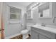 Bathroom featuring white cabinets, a sink, and a toilet at 1401 S Palmetto Ave # 300, Daytona Beach, FL 32114
