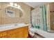 Cozy bathroom featuring a wooden vanity, framed mirror, and a bathtub with a shower at 1401 S Palmetto Ave # 300, Daytona Beach, FL 32114