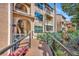 Inviting condo building featuring a wooden walkway and lush tropical landscaping at 1401 S Palmetto Ave # 300, Daytona Beach, FL 32114