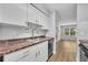 Bright kitchen featuring white cabinets, stainless steel appliances, and dark countertops at 1401 S Palmetto Ave # 300, Daytona Beach, FL 32114