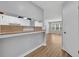 Kitchen passthrough viewing the great room with new flooring at 1401 S Palmetto Ave # 300, Daytona Beach, FL 32114