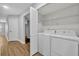 Convenient laundry area with modern washer and dryer, plus storage shelving at 1401 S Palmetto Ave # 300, Daytona Beach, FL 32114