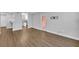Open-concept living area with laminate floors, a door to balcony, and a kitchen view at 1401 S Palmetto Ave # 300, Daytona Beach, FL 32114