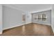 Unstaged living room with laminate floors, a sliding glass door, and a window at 1401 S Palmetto Ave # 300, Daytona Beach, FL 32114