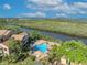 Beautiful aerial view of a community pool and surrounding sun loungers located on a waterfront property at 1401 S Palmetto Ave # 300, Daytona Beach, FL 32114