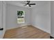 Cozy bedroom featuring wood-look flooring, a ceiling fan, and a view of the lawn at 1427 18Th St, Orange City, FL 32763