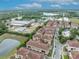 Wide angle view of townhomes with terracotta roofs near green spaces, adjacent to community amenities and parking at 1436 Lobelia Dr, Lake Mary, FL 32746