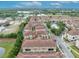 Bird's-eye view of townhomes with tiled roofs, showcasing street layout, green spaces, and nearby community facilities at 1436 Lobelia Dr, Lake Mary, FL 32746