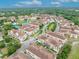 Aerial view of townhomes, highlighting community amenities, tiled roofs, lush landscaping, and proximity to recreational features at 1436 Lobelia Dr, Lake Mary, FL 32746