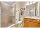 Clean bathroom with tiled walk-in shower, vanity, and neutral color palette at 1436 Lobelia Dr, Lake Mary, FL 32746