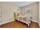Comfortable bedroom featuring a vibrant floral comforter, wood floors and a bright window at 1436 Lobelia Dr, Lake Mary, FL 32746