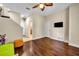 Open bonus room with wood floors leading to the bathroom and a TV mounted on the wall at 1436 Lobelia Dr, Lake Mary, FL 32746