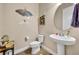 Quaint half-bathroom with a pedestal sink and decorative wall accents at 1436 Lobelia Dr, Lake Mary, FL 32746