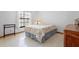 Simple bedroom featuring a bed, window, tile flooring, and furniture at 1439 Waterview Dr, Deltona, FL 32738