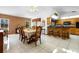 Bright dining area featuring vaulted ceilings, tile floors, a brick accent wall, and views to the kitchen at 1439 Waterview Dr, Deltona, FL 32738