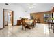 Bright dining area featuring vaulted ceilings, tile floors, a brick accent wall, and views to the backyard at 1439 Waterview Dr, Deltona, FL 32738