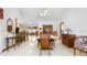 Open dining area featuring vaulted ceilings, tile floors, neutral paint, and traditional furnishings at 1439 Waterview Dr, Deltona, FL 32738