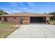 Brick ranch-style home with an attached garage and a screened-in lanai at 1439 Waterview Dr, Deltona, FL 32738