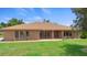 Charming single-story brick home with mature landscaping, a manicured lawn, and a welcoming front entrance at 1439 Waterview Dr, Deltona, FL 32738