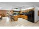 Bright kitchen featuring an island with barstools and a full suite of black appliances at 1439 Waterview Dr, Deltona, FL 32738