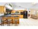 Bright kitchen featuring an island with barstools and a full suite of black appliances at 1439 Waterview Dr, Deltona, FL 32738