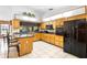 Bright kitchen featuring an island with barstools and a full suite of black appliances at 1439 Waterview Dr, Deltona, FL 32738