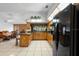 Bright kitchen featuring an island with barstools and a full suite of black appliances at 1439 Waterview Dr, Deltona, FL 32738