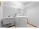 Functional laundry room with sink, washer, and shelving at 1439 Waterview Dr, Deltona, FL 32738