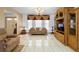 Cozy living room featuring tiled floors, sofa, and built in entertainment center at 1439 Waterview Dr, Deltona, FL 32738