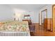 Comfortable main bedroom featuring hardwood floors, a floral-patterned bedspread, and traditional furnishings at 1439 Waterview Dr, Deltona, FL 32738