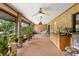 Spacious covered patio with brick floors, fans and potted plants at 1439 Waterview Dr, Deltona, FL 32738