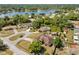 Scenic aerial view of homes nestled among lush greenery with a beautiful lake in the background, offering a tranquil setting at 1440 Portola Ave, Deltona, FL 32738
