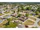Expansive aerial view of a neighborhood featuring well-maintained homes and mature trees, with lakes in the distance at 1440 Portola Ave, Deltona, FL 32738