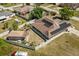 Aerial view of home with solar panels, surrounded by fencing and various trees at 1440 Portola Ave, Deltona, FL 32738