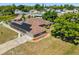 Aerial view of home with solar panels, a long driveway, and well-maintained landscaping at 1440 Portola Ave, Deltona, FL 32738